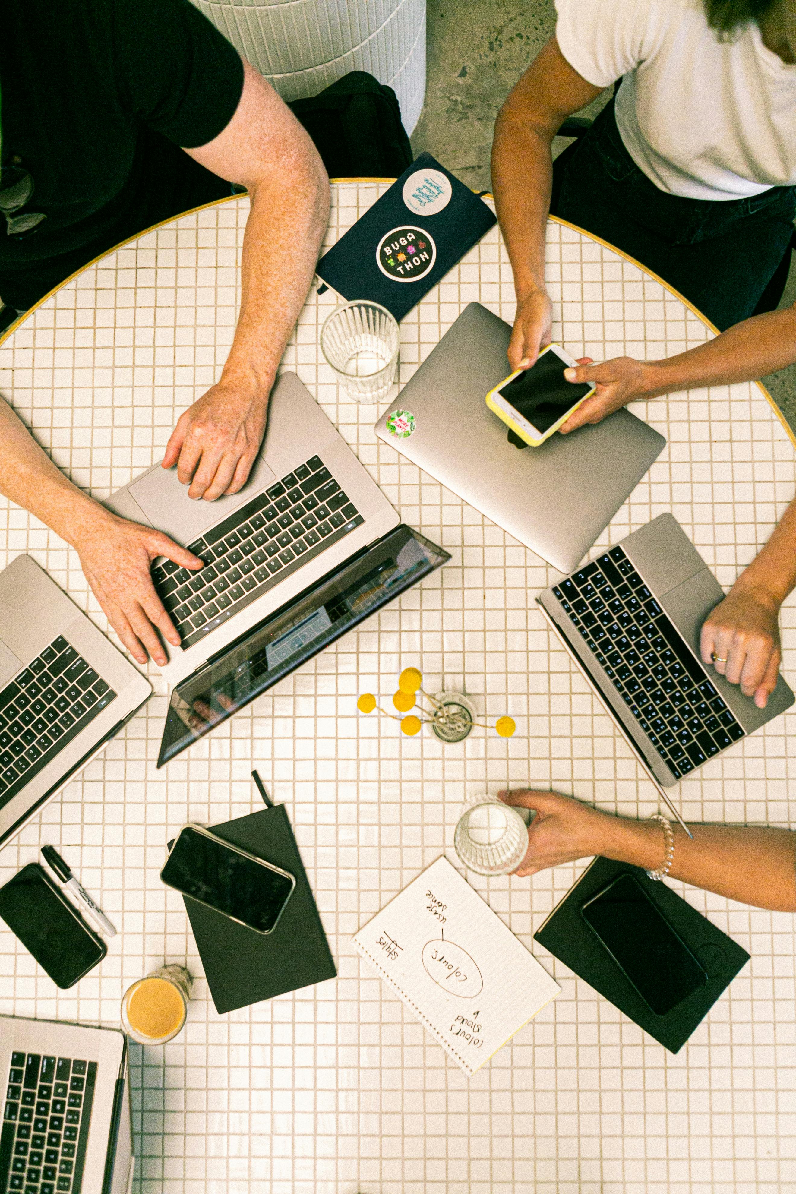 Team working together around laptops and notes